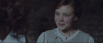Movie still from “Suffragette” (2015), directed by Sarah Gavron – A young girl is smiling for the camera; Close Up shot, High angle