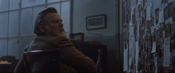 Movie still from “Suffragette” (2015), directed by Sarah Gavron – An older man sitting in front of a window; Medium shot, Over the shoulder angle