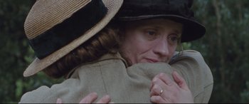 Movie still from “Suffragette” (2015), directed by Sarah Gavron – A woman in a hat and a coat hugging herself; Close Up shot, Over the shoulder angle