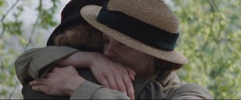 Movie still from “Suffragette” (2015), directed by Sarah Gavron – A woman wearing a straw hat is hugging another woman; Close Up shot, High angle