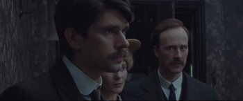 Movie still from “Suffragette” (2015), directed by Sarah Gavron – A group of people standing next to each other in a room; Close Up shot, Over the shoulder angle