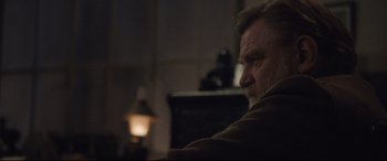 Movie still from “Suffragette” (2015), directed by Sarah Gavron – An older man sitting in front of a lamp; Close Up shot, Over the shoulder angle