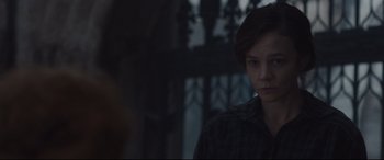 Movie still from “Suffragette” (2015), directed by Sarah Gavron – A woman standing in front of an ornate window; Close Up shot, Over the shoulder angle