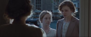 Movie still from “Suffragette” (2015), directed by Sarah Gavron – A group of people standing next to each other on a street; Close Up shot, Over the shoulder angle