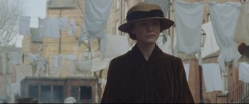 Movie still from “Suffragette” (2015), directed by Sarah Gavron – A woman in a hat and a brown coat; Medium shot, Low angle