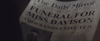 Movie still from “Suffragette” (2015), directed by Sarah Gavron – An old newspaper with a picture of an elderly woman; Extreme Close Up shot, Overhead angle