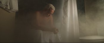 Movie still from “Sully” (2016), directed by Clint Eastwood – An older man is sitting in a bed; Medium shot, High angle