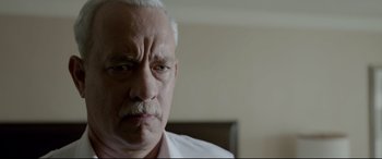 Movie still from “Sully” (2016), directed by Clint Eastwood – An old man with a mustache and a white beard; Close Up shot, Low angle