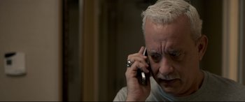 Movie still from “Sully” (2016), directed by Clint Eastwood – An older man talking on a cell phone; Close Up shot, High angle