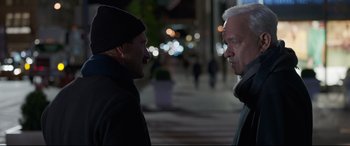 Movie still from “Sully” (2016), directed by Clint Eastwood – Two men standing next to each other on the sidewalk; Close Up shot, Over the shoulder angle