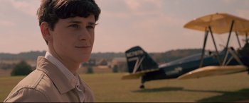 Movie still from “Sully” (2016), directed by Clint Eastwood – A man standing in front of an airplane in a field; Close Up shot, Over the shoulder angle