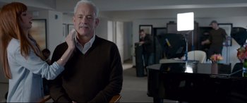 Movie still from “Sully” (2016), directed by Clint Eastwood – An older man sitting in front of a grand piano; Medium shot, Over the shoulder angle