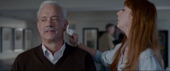 Movie still from “Sully” (2016), directed by Clint Eastwood – An older man getting his hair combed by a young woman; Close Up shot, Over the shoulder angle