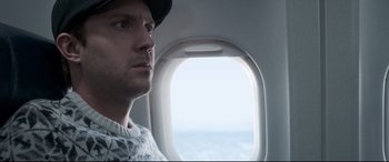 Movie still from “Sully” (2016), directed by Clint Eastwood – A person looking out of an airplane window; Close Up shot, Low angle