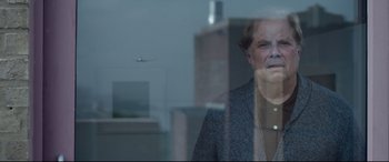 Movie still from “Sully” (2016), directed by Clint Eastwood – An older woman looking out of a window at an airplane; Close Up shot, Over the shoulder angle