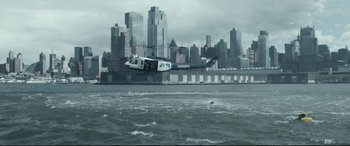 Movie still from “Sully” (2016), directed by Clint Eastwood – A helicopter flying over a body of water near a city; Extreme Wide shot, High angle