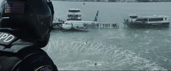 Movie still from “Sully” (2016), directed by Clint Eastwood – An airplane in the water with people standing on it; Extreme Wide shot, High angle