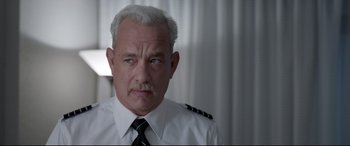 Movie still from “Sully” (2016), directed by Clint Eastwood – An older man wearing a white shirt and a tie; Close Up shot, Over the shoulder angle