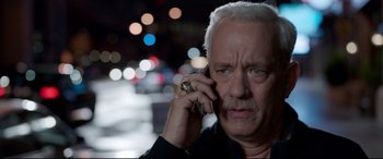Movie still from “Sully” (2016), directed by Clint Eastwood – An older man talking on a cell phone in the dark; Close Up shot, High angle