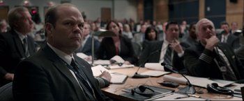 Movie still from “Sully” (2016), directed by Clint Eastwood – A group of people sitting around a table; Close Up shot, Over the shoulder angle