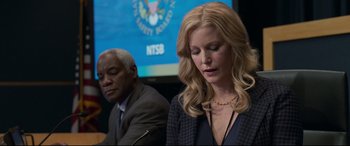 Movie still from “Sully” (2016), directed by Clint Eastwood – A woman is standing next to an older man; Close Up shot, Over the shoulder angle