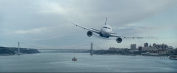 Movie still from “Sully” (2016), directed by Clint Eastwood – An airplane is flying over a body of water; Extreme Wide shot, Low angle