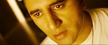 Movie still from “Sunshine” (2007), directed by Danny Boyle – A man's face in a sepia - toned photo; Extreme Close Up shot, High angle