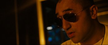 Movie still from “Sunshine” (2007), directed by Danny Boyle – A person wearing sunglasses; Close Up shot, Low angle