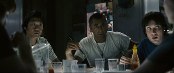 Movie still from “Sunshine” (2007), directed by Danny Boyle – A man sitting in front of a table holding chopsticks; Close Up shot, Over the shoulder angle