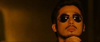 Movie still from “Sunshine” (2007), directed by Danny Boyle – A person wearing sunglasses; Close Up shot, Low angle