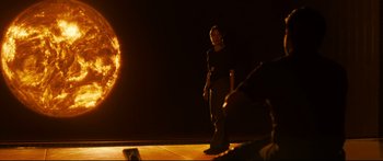 Movie still from “Sunshine” (2007), directed by Danny Boyle – A woman standing on a stage in front of a camera; Wide shot, Over the shoulder angle