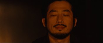 Movie still from “Sunshine” (2007), directed by Danny Boyle – A person with their eyes closed; Close Up shot, Low angle