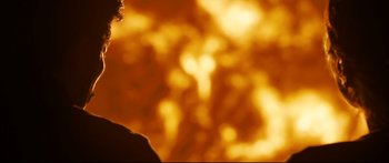 Movie still from “Sunshine” (2007), directed by Danny Boyle – A person standing in front of an orange sky; Close Up shot, Low angle