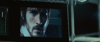 Movie still from “Sunshine” (2007), directed by Danny Boyle – A man's face on a television screen; Extreme Close Up shot, Over the shoulder angle