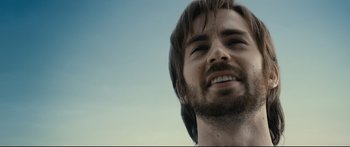 Movie still from “Sunshine” (2007), directed by Danny Boyle – A man's face with long brown hair; Close Up shot, Low angle