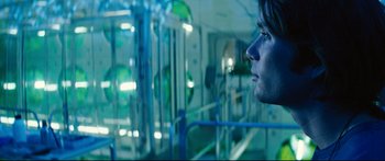 Movie still from “Sunshine” (2007), directed by Danny Boyle – A man looking out a window at a room; Close Up shot, Over the shoulder angle