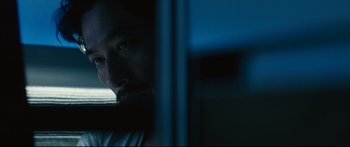 Movie still from “Sunshine” (2007), directed by Danny Boyle – A man looking out of a window at night; Close Up shot, Over the shoulder angle