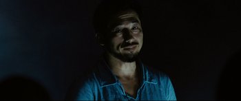 Movie still from “Sunshine” (2007), directed by Danny Boyle – A person wearing a blue shirt in the dark; Close Up shot, Low angle