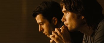 Movie still from “Sunshine” (2007), directed by Danny Boyle – Two men sitting side - by - side in a dark room; Close Up shot, Over the shoulder angle