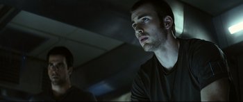 Movie still from “Sunshine” (2007), directed by Danny Boyle – A man looking up at the ceiling in a dark room; Close Up shot, Low angle