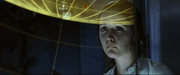 Movie still from “Sunshine” (2007), directed by Danny Boyle – A young woman is looking out a window at the camera; Close Up shot, Over the shoulder angle