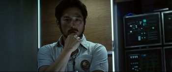 Movie still from “Sunshine” (2007), directed by Danny Boyle – A man in a white shirt is holding his hand to his face; Close Up shot, Low angle