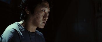 Movie still from “Sunshine” (2007), directed by Danny Boyle – A young man with dark hair looking to his left; Close Up shot, Low angle