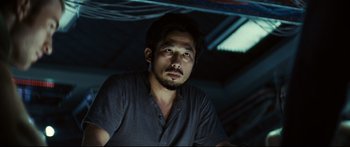 Movie still from “Sunshine” (2007), directed by Danny Boyle – A person sitting in a room; Close Up shot, Low angle