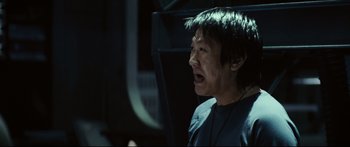 Movie still from “Sunshine” (2007), directed by Danny Boyle – An asian man is crying in a dark room; Close Up shot, Low angle