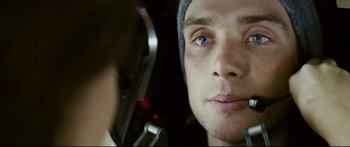 Movie still from “Sunshine” (2007), directed by Danny Boyle – A man's face in a car mirror; Close Up shot, Overhead angle