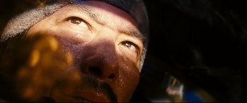 Movie still from “Sunshine” (2007), directed by Danny Boyle – A man's face with the sun shining on his face; Extreme Close Up shot, Overhead angle