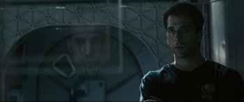 Movie still from “Sunshine” (2007), directed by Danny Boyle – A man standing in front of a mirror in a room; Close Up shot, Over the shoulder angle