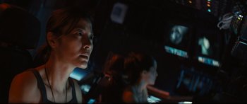 Movie still from “Sunshine” (2007), directed by Danny Boyle – A woman looking at the camera in a dark room; Close Up shot, Over the shoulder angle