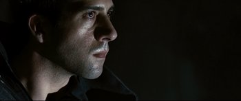 Movie still from “Sunshine” (2007), directed by Danny Boyle – A person's face in the dark; Close Up shot, Low angle